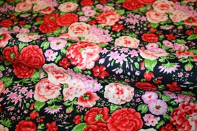 Bomuldsstof med farvestrålende blomsterprint