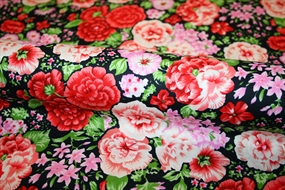 Bomuldsstof med farvestrålende blomsterprint