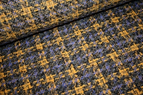 Uld bouclé i gule, grå og blå nuancer