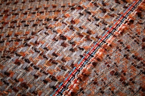 Uld bouclé stof i brændte nuancer