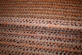 Uld bouclé stof i brændte nuancer