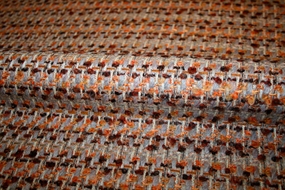 Uld bouclé stof i brændte nuancer