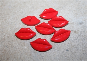 Knap formet som en rød kymund